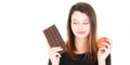 Portrait of young pretty woman cute with apple and chocolate bar temptation Royalty Free Stock Photo