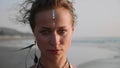 Portrait of young woman with Indian bindi looking to camera