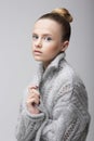 Portrait of Young Pretty Woman in Knitted Woolen Gray Jersey