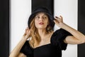 Portrait of a young pretty woman in a black hat and dress Royalty Free Stock Photo