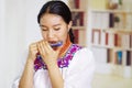 Portrait of young pretty woman wearing beautiful traditional andean clothing, sitting down with while playing the Royalty Free Stock Photo