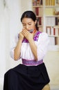 Portrait of young pretty woman wearing beautiful traditional andean clothing, sitting down with while playing the Royalty Free Stock Photo