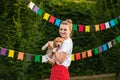 Portrait of young woman holding young red cute beagle puppy. Flags background Royalty Free Stock Photo