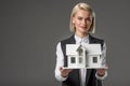 portrait of young real estate agent with house model Royalty Free Stock Photo