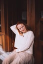 Portrait of young red haired woman in white sweater Royalty Free Stock Photo