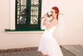 Portrait of young redhead bride with bouquet of roses. Royalty Free Stock Photo