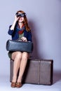 Young redhead girl with suitcase and binocular Royalty Free Stock Photo