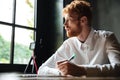 Portrait of a young redhead man writing in a notebook Royalty Free Stock Photo