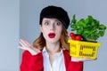 Woman in red cardigan and hat with herbs and tomatoes in yellow Royalty Free Stock Photo