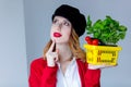 Woman in red cardigan and hat with herbs and tomatoes in yellow Royalty Free Stock Photo