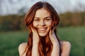 Portrait of a young redheaded woman looking into the camera and smiling, close-up portrait of a laughing woman in the Royalty Free Stock Photo