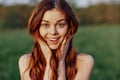 Portrait of a young redheaded woman looking into the camera and smiling, close-up portrait of a laughing woman in the Royalty Free Stock Photo