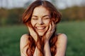 Portrait of a young redheaded woman looking into the camera and smiling, close-up portrait of a laughing woman in the Royalty Free Stock Photo