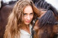 Portrait of young rider woman with her bay horse Royalty Free Stock Photo