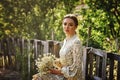 Portrait of a young romantic beautiful girl with a bunch of daisies on a summer walk Royalty Free Stock Photo