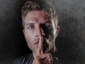 Portrait of young 30s man with finger on his lips in silence and shut up hand gesture warning or threatening not to speak in polit Royalty Free Stock Photo