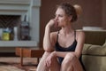 Portrait of young sad woman sitting on the floor at home Royalty Free Stock Photo