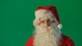 Portrait of a young Santa Claus on a green background Royalty Free Stock Photo