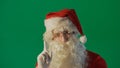 Portrait of a young Santa Claus on a green background Royalty Free Stock Photo