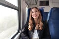 Portrait of young satisfied woman traveling with public transport sitting relaxed thoughtless. Looking at camera Royalty Free Stock Photo