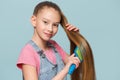 Portrait of a young schoolgirl. The choice between a book and a candy. Thumbs up. Copycpase