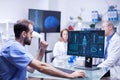 Portrait of young scientist looking at monitor computer checking male body