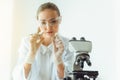 Portrait of young scientist research is looking at the microscope slide in the laboratory room, Biotechnology, Science, Chemistry Royalty Free Stock Photo