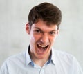 Portrait of young screaming guy in studio Royalty Free Stock Photo