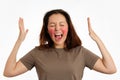 Portrait of a young screaming woman with red inflamed cheeks. White background. The concept of rosacea and couperose