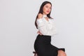 Portrait of young seated businesswoman wearing a white shirt