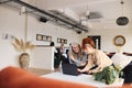 Portrait of young and senior white businesswomen looking at laptop in open plan office workspace, smiling and discussing Royalty Free Stock Photo