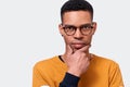 Portrait of young serious African American male in eyeglasses looking seriously at the camera. People, emotion concept Royalty Free Stock Photo
