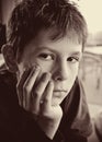 Portrait of young serious boy reflecting Royalty Free Stock Photo