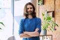 Portrait of young confident handsome man with crossed arms, looking at camera Royalty Free Stock Photo