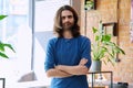 Portrait of young confident handsome man with crossed arms, looking at camera Royalty Free Stock Photo