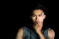 Portrait of young serious handsome boy with muscle on the black background Royalty Free Stock Photo