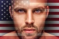 A portrait of a young serious man, in whose eyes is reflected the national flag Royalty Free Stock Photo