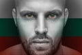 A portrait of a young serious man, in whose eyes is reflected the national flag Royalty Free Stock Photo