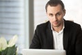 Portrait of handsome serious businessman in office, looking at c Royalty Free Stock Photo