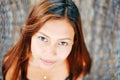 Portrait of young beautiful girl sitting on rattan hammock, blurry background Royalty Free Stock Photo