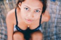 Portrait of young beautiful girl sitting on rattan hammock, blurry background Royalty Free Stock Photo