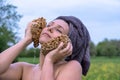 portrait of a young sexy beautiful naked woman with towel wrapped head, taking a bath in green nature meadow, washing her head Royalty Free Stock Photo