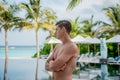 Portrait of young sexy handsome man at the tropical island luxury resort