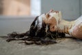 Portrait of a young, sexy woman in white color painted decorative, lies on the floor in the studio. Creative expressive abstract Royalty Free Stock Photo