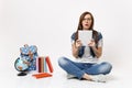 Portrait of young shocked scared woman student in glasses holding pencil, notebook sitting near globe, backpack, school Royalty Free Stock Photo