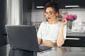 Portrait of a young shocked woman in glasses sitting in front of a laptop computer, looking at the screen. Funny facial Royalty Free Stock Photo