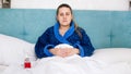 Portrait of young sick woman with high temperature got flu ling in bed at home Royalty Free Stock Photo