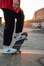 Trendy guy skater posing at skatepark at sunset Royalty Free Stock Photo