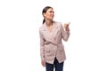 portrait of a young slender brunette business woman with ponytail dressed in a jacket and jeans Royalty Free Stock Photo