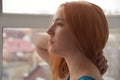 Pensive young woman with ginger hair